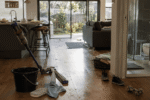 Lived-in Australian home with cleaning tools, pet hair, crumbs and everyday clutter.
