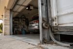 Worn garage door roller, cable and track in an Australian suburban garage.